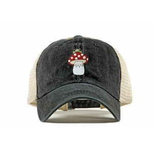Detail of mushroom and frog embroidery on a grey washed cotton and beige mesh trucker hat