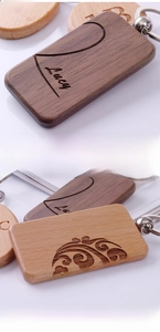 Macro shot of custom laser engraved black walnut wood keychain with cloud patterns