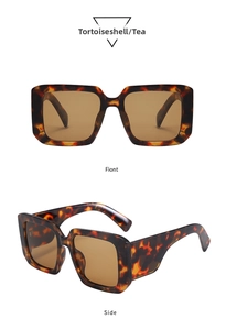 Detail view of oversized Y2K tortoise frame sunglasses with brown lenses and wide temples
