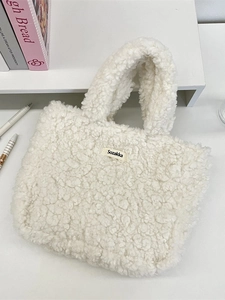 White plush tote bag with Sozakka brand logo on a cozy desk setting for women
