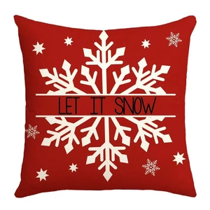 Detail of red Christmas pillowcase featuring LET IT SNOW text and white snowflake pattern