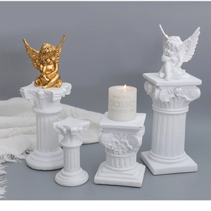 Detail of four white Roman column display stands with elegant classical carvings