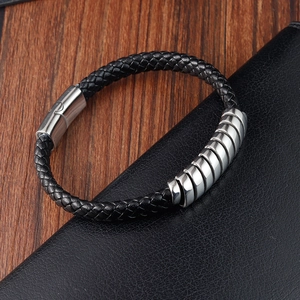 Close-up of black braided leather bracelet with silver stainless steel beads on leather
