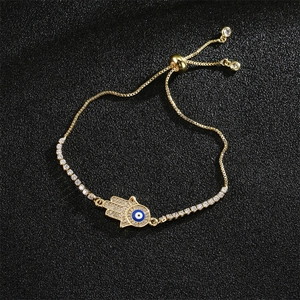 Detailed view of gold Hamsa hand and Evil Eye charm bracelet with adjustable chain