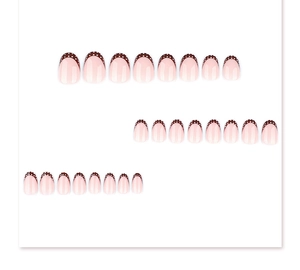 Detailed view of French tip press-on nails in brown with white polka dots and round shape