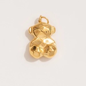 Detail shot of a golden geometric teddy bear pendant with a polished finish and top ring