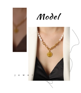 Detail of freshwater pearl necklace with vintage coin pendant and gold plated chain
