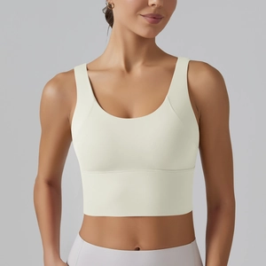 Close-up of cream-colored U-neck sports bra with wide straps and high-elastic waist band