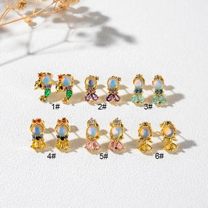 Six pairs of gold-plated fish tail stud earrings with colorful opal and zircon inlays