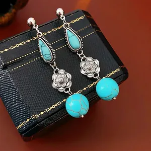 Vintage silver flower drop earrings with turquoise stones and long tassels on black leather
