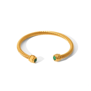 Close-up of golden cable twisted cuff bangle featuring green malachite stones