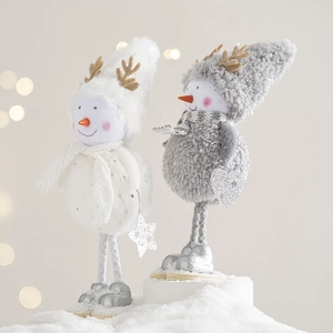 Cute Christmas snowman figurines with felt antlers and knit scarves on wooden bases