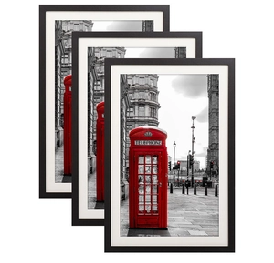 Detail view of modern black photo frames with London red telephone box art prints