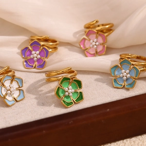 Detailed view of 18K gold plated multi-layer rings with colorful enamel flower and pearl