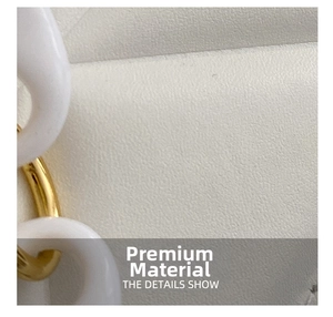 Detailed macro view of white lychee textured leather and resin gold chain link