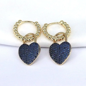 Gold hoop earrings featuring a blue zircon paved heart pendant in a stylish modern design