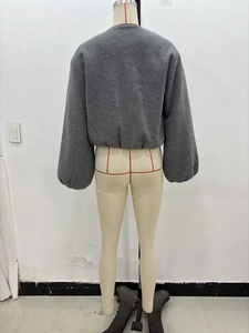 Back view of a grey cropped bomber jacket on a mannequin showing fit and design