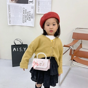 Toddler girl modeling pink plaid tweed mini purse with pearl handle and bow accent