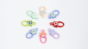 Macro shot of colorful flower spring ring carabiners in various pastel shades for DIY crafts