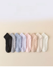 Close-up of non-slip silicone grips on the soles of colorful coral fleece socks