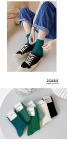 Detail of ribbed combed cotton crew socks for women in various green shades