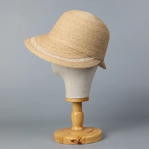 Elegant wide brim raffia sun hat with white lace trim detail for summer vacation