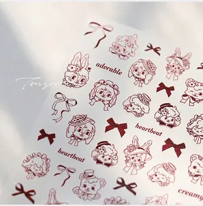 Detail of vintage red-brown nail stickers with hand-drawn cartoon animals and bows