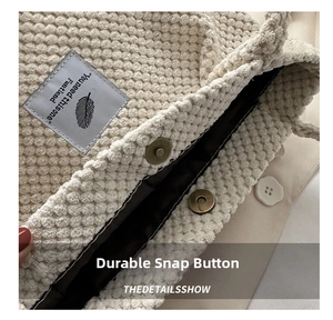 Detail of cream popcorn texture tote bag showing strong magnetic closure and interior lining
