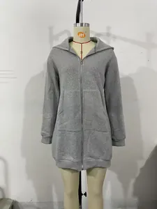 Detail of dark grey zip-up hoodie featuring a large kangaroo pocket and ribbed cuffs