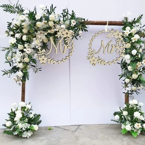 Wooden Mr and Mrs wedding chair signs with floral wreaths hanging on white roses