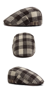 Detail view of plaid wool beret featuring side metal buckle and vintage brown check pattern