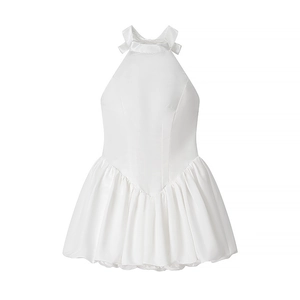 Detail of white halter neck satin mini dress with elegant bow tie and ruffled hemline
