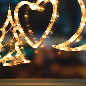 LED Christmas window hanging lights with star, moon, and heart shapes in warm white glow