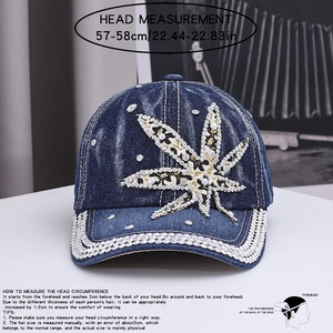 Detailed view of denim baseball cap featuring maple leaf rhinestone and stud embellishments