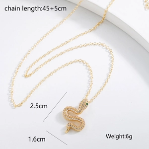Detail view of 18K gold snake pendant with cubic zirconia and size dimensions