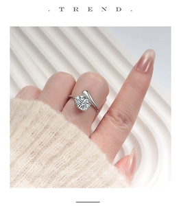 Close-up of a sterling silver twisted ring with a large round-cut sparkling diamond