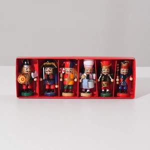 Front view of six wooden Christmas nutcracker soldiers in a red gift display box