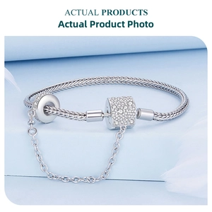 Detail of S925 sterling silver snake chain bracelet with pave zirconia charm and safety chain