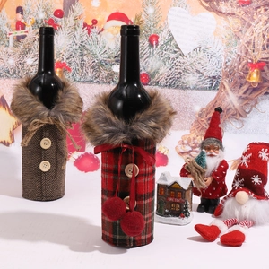 Detail of Christmas wine bottle covers featuring plaid patterns and plush collars