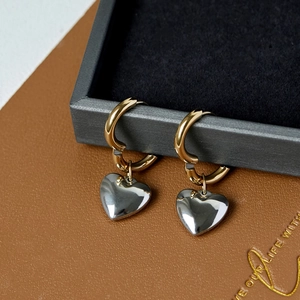 Two-tone heart pendant hoop earrings in gold and silver stainless steel finish