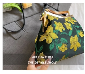 Side view of dark green handbag with yellow flower embroidery and amber U-shaped handle