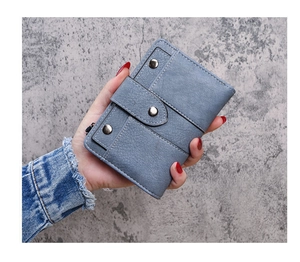 Detail of blue faux leather wallet with metallic snap closure and side zipper pocket