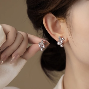 Elegant silver earrings featuring lavender pearl clusters and crystal leaf accents