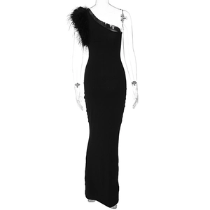 Detail of elegant black one-shoulder evening gown with feather accents on the strap