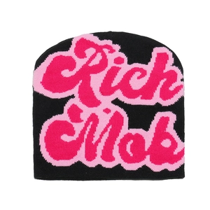 Detail of black knit beanie featuring pink Rich Mob jacquard graffiti lettering