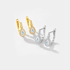 Detailed close-up of S925 sterling silver drop earrings with blue stones and hallmarks