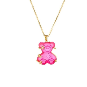 Detailed close-up of a pink resin bear pendant with gold stars on a delicate gold chain
