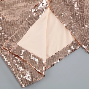 Detail of rose gold sequins with metal snap fastener and soft beige fabric lining