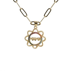 Close-up of gold MAMA heart pendant with colorful zircon stones on studio white background