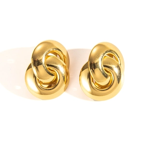 Macro shot of interlocking double-ring gold earrings with a polished mirror finish